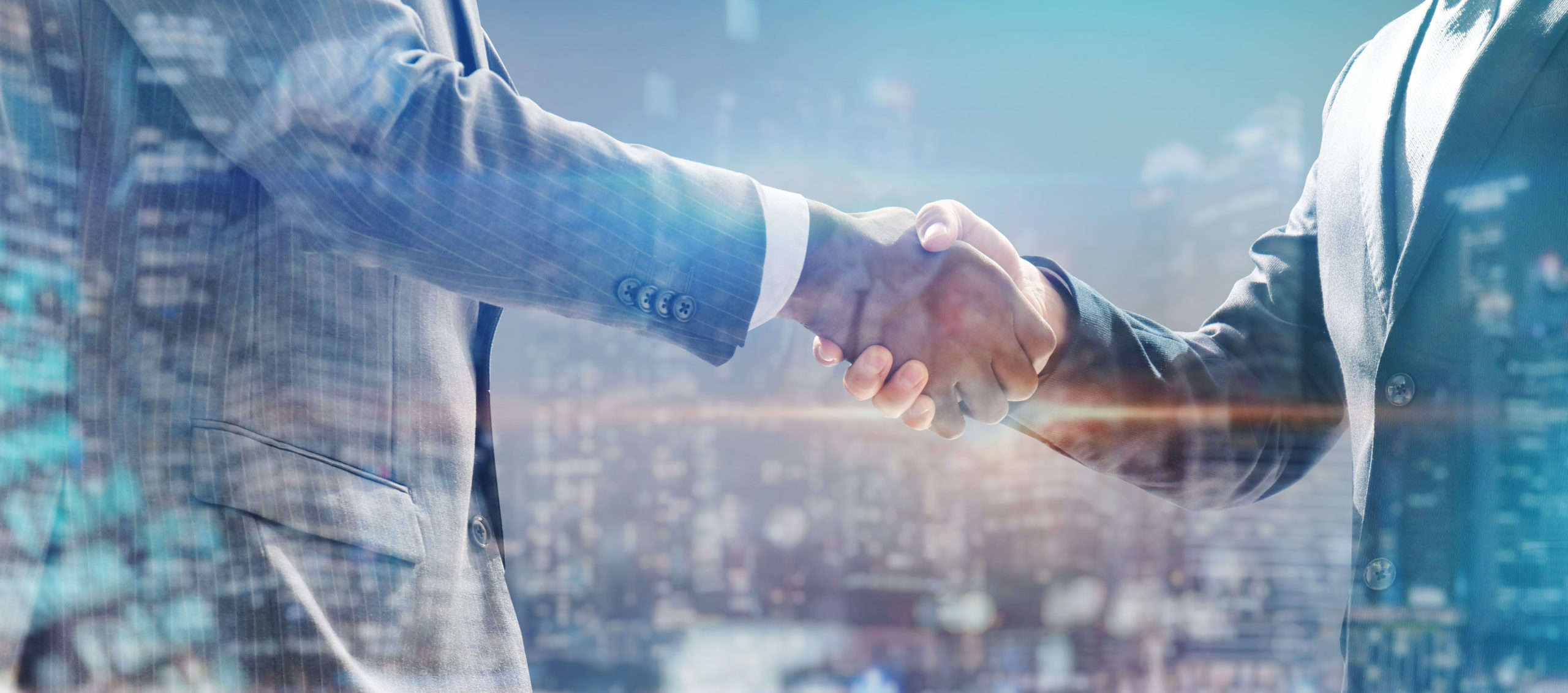 Selling an Accounting Practice concept. handshake of business people with skyscrapers background and finance and marketing business conclusion.